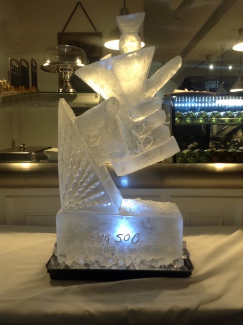 Hand holding a Martini Glass Vodka Luge from Passion for Ice